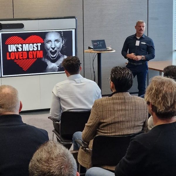 Jetts UK Managing Director James Garner presents to an audience at the HSBC Meet The Brands event. His slide reads 'UK'S MOST LOVED GYM'